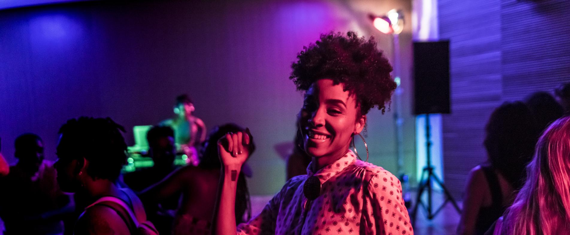 Smiling woman dancing at a night club in Grand Rapids