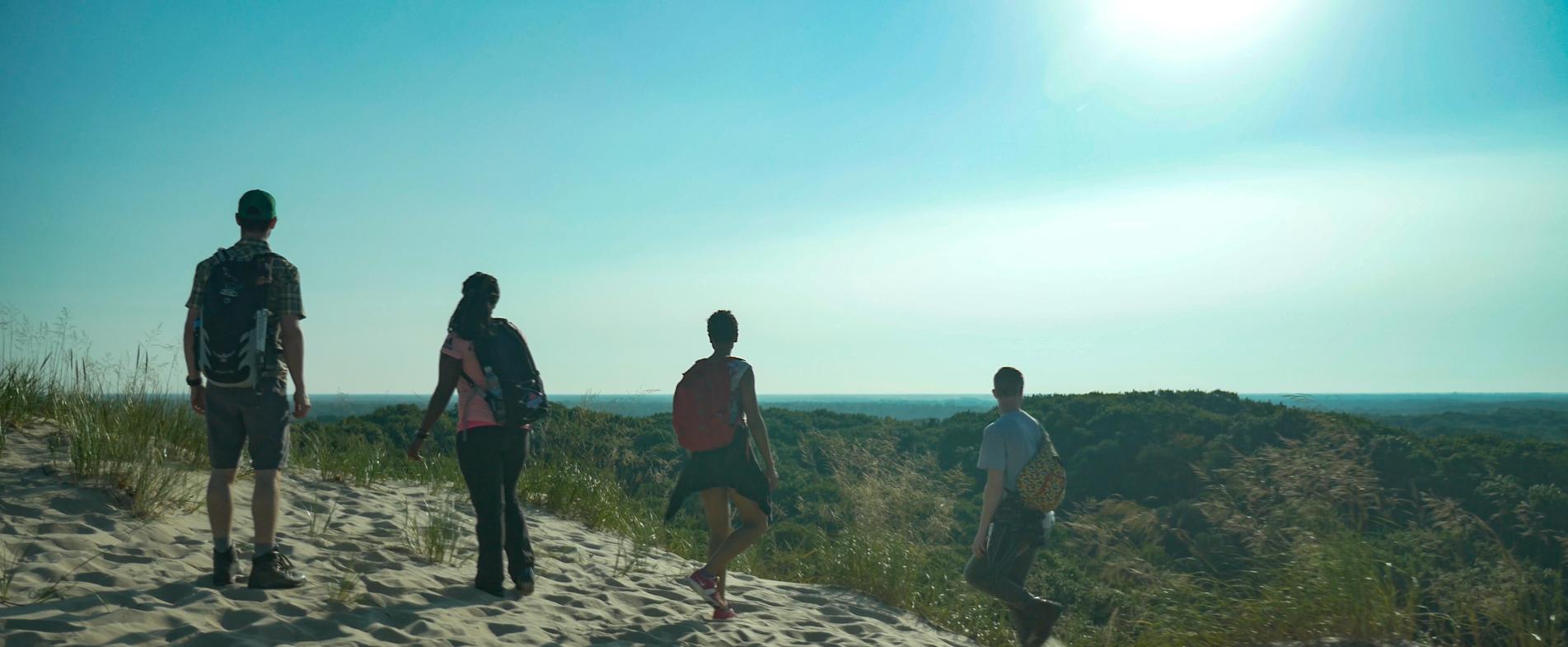 Hiking a trail in the PJ Hoffmaster State Park, which leads to a beach on Lake Michigan.