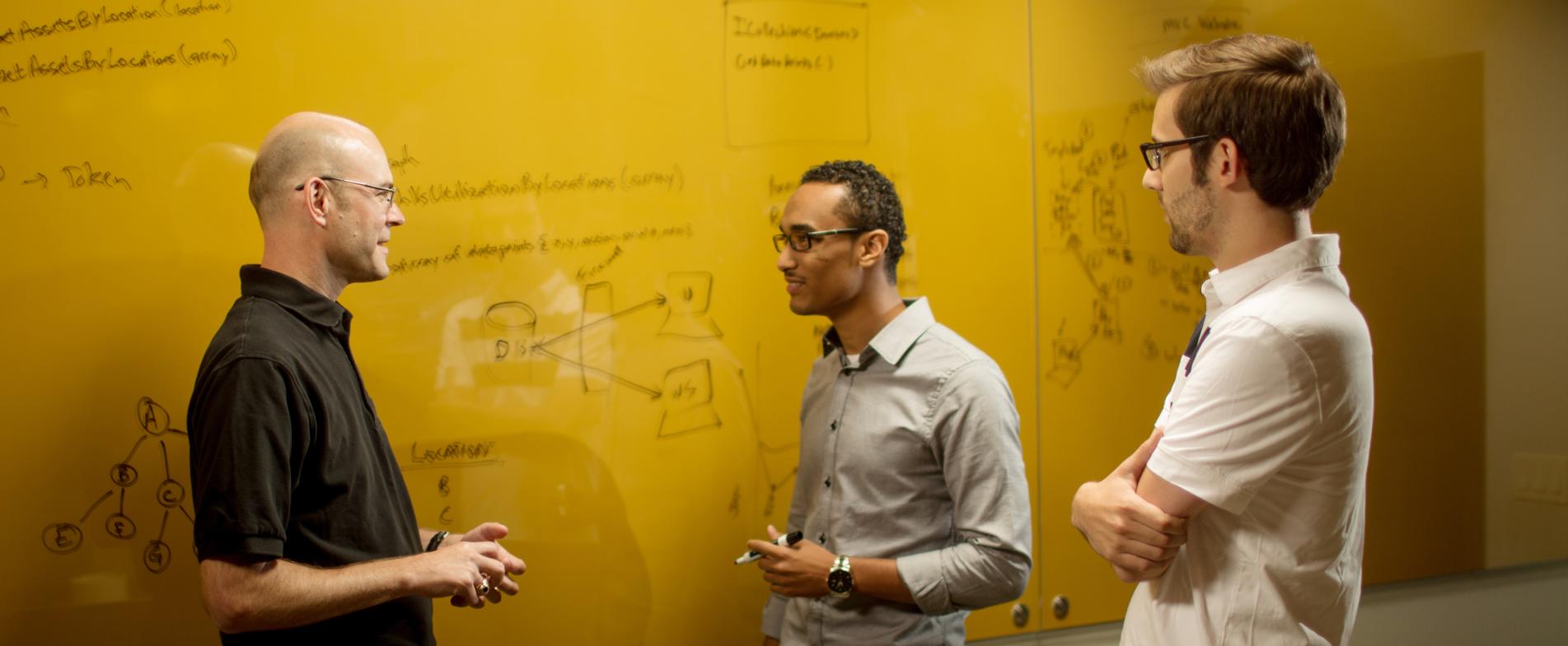 Workers at Open Systems Technologies working on a problem.