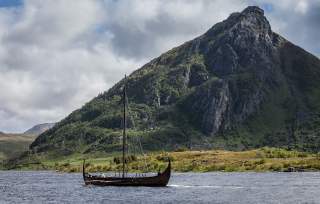 A traditional Norwegian Viking ship on the water near Lofoten, Northern Norway