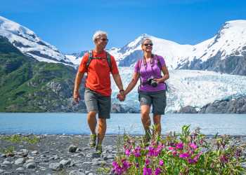 Portage Glacier awaits at the far end of Portage Pass Trail. A couple strolls the lake.