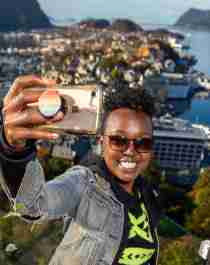 A woman taking a selfie at Aksla in Ålesund, Norway.
