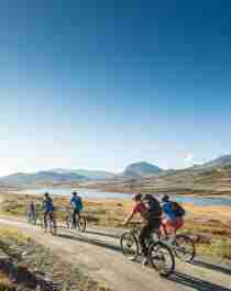 People biking on a gravel road in Ål in Hemsedal, Eastern Norway