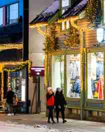 Two girls strolling in the Christmas decorated streets in Tromsø