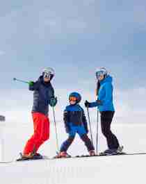 A family of three is skiing in the slopes of Trysilfjellet mountain in Trysil, Eastern Norway.