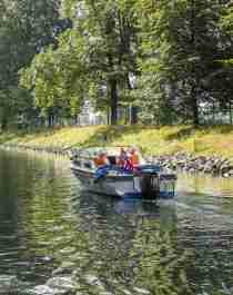 A boat drives in a leisurely pace in the Hortenkanalen canal in Horten in Vestfold, Eastern Norway
