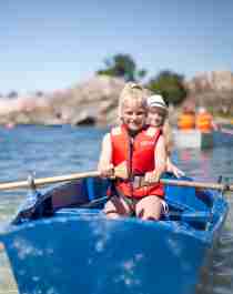 Two children in a rowing boat near Bragdøya outside of Kristiansand, Southern Norway