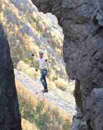 Woman climbing via ferrata Ravnfloget