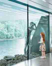 Girl looking at a silver sculpture at the Kistefos Museum in Norway