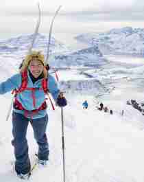 Woman climbing mount Himmeltind on a ski touring trip in Lofoten, Northern Norway