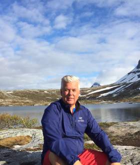 Bjørn Heitmann sitting by mountain lake, Bodø Northern Norway