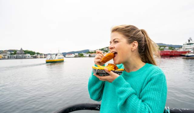 A woman eating fish and chips, locally called "Fishan" in Kristiansund