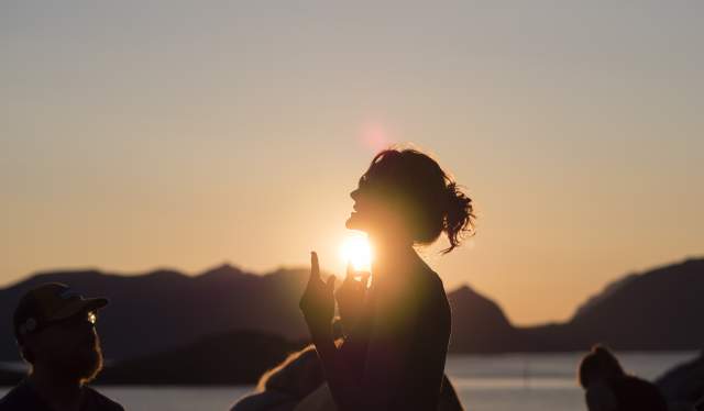 People attending the Trevarefest festival under the midnight sun in Henningsvær, Northern Norway