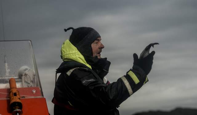 Rolf Malnes from Lofoten Adventure holding a fish on a RIB boat in Henningsvær in Lofoten, Northern Norway