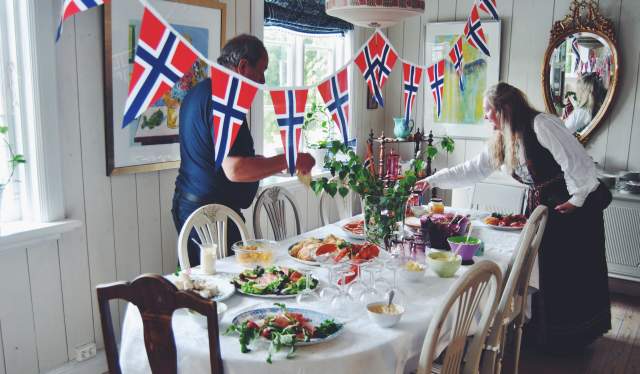 Two people getting ready for a 17 May breakfast on the Norwegian Constitution Day
