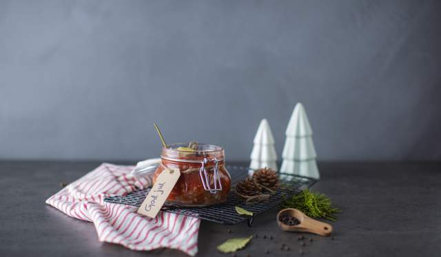 Traditional Norwegian pickled herring in a glass jar.