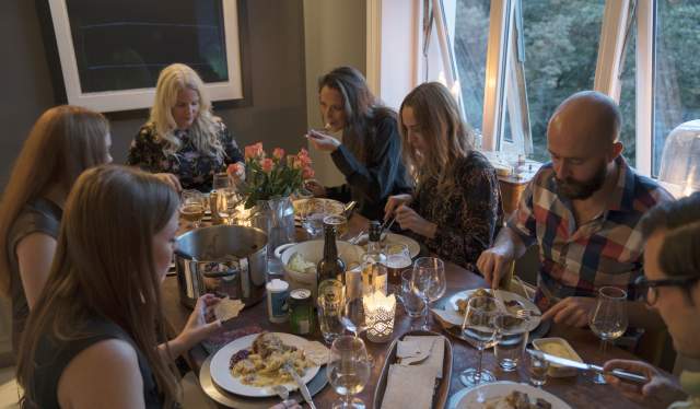 People around a dinner table eating fårikål lamb stew in Oslo, Eastern Norway