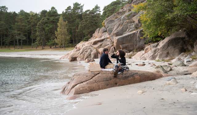 Couple sitting on the skerries in Southern Norway