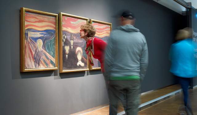 People looking at Edvard Munch’s Scream at The Munch Museum in Oslo