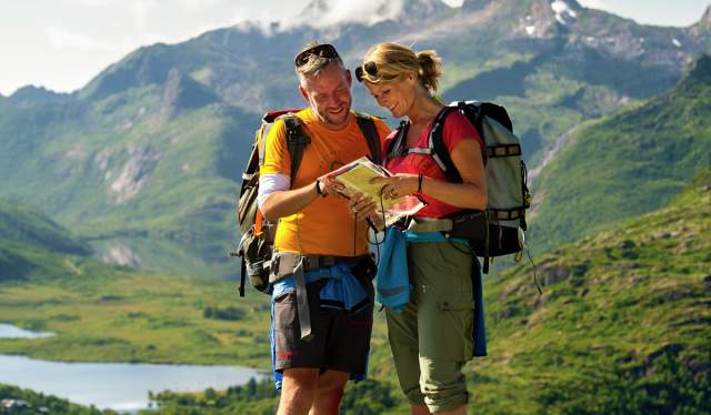 Couple mapreading in the mountains of Lofoten, Northern Norway
