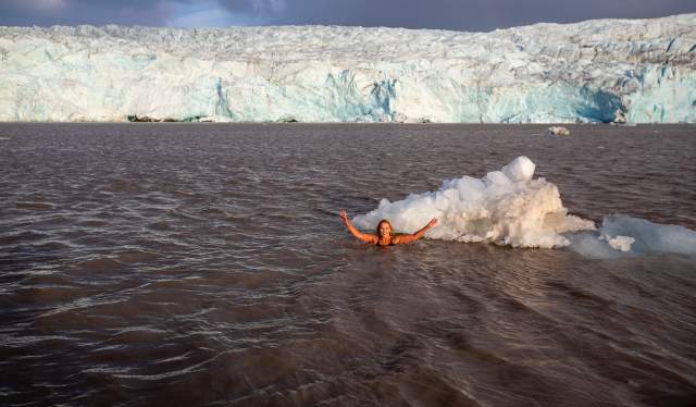 Anne Kristin Møller swimming in front of the Nordenskiöld glacier, Svalbard