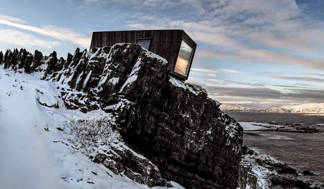 A birdwatching shelter in the snowy landscape of Kongsfjord, Northern Norway