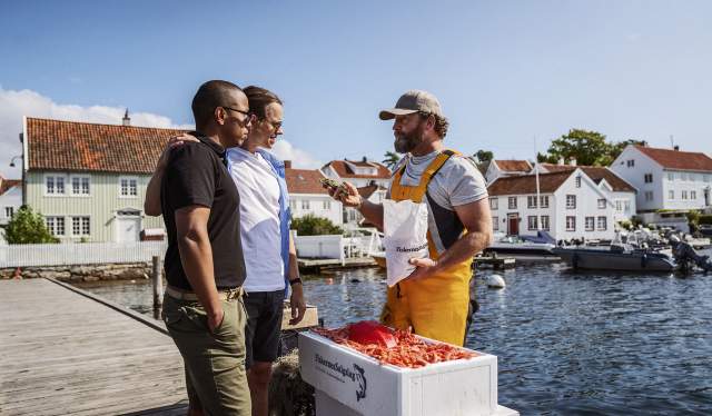 Friends buying fresh shrimps from local fisherman in Southern Norway