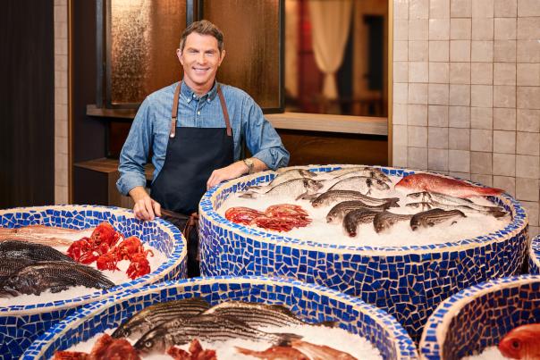World famous chef Bobby Flay standing proudly in front of his fresh seafood at Amalfi in Las Vegas.