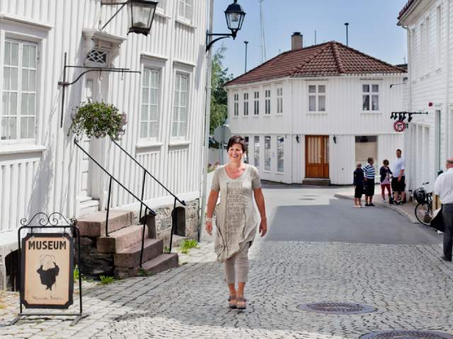 A woman walking past the Ibsen museum in Grimstad in Southern Norway.