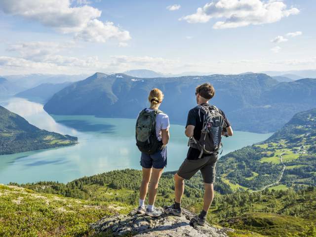 Two people admiring the view from the top of mount Molden in the Sognefjord area of Fjord Norway