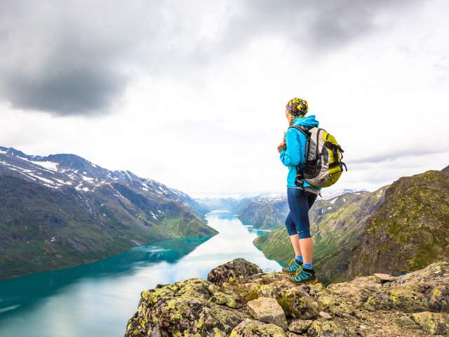 A woman enjoying the view of Lake Gjende from the top of Besseggen in Jotunheimen, Eastern Norway