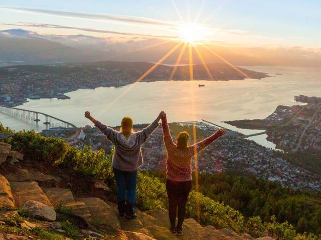 Two women are hiking up the Sherpa staircase to Mount Storsteinen in Tromsø, Northern Norway