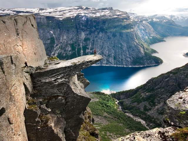 A person on the mountain plateau Trolltunga above Lake Ringedalsvatnet in the Hardangerfjord region, Fjord Norway