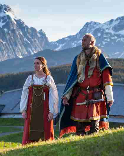 Two Vikings in front of the Viking chieftains longhouse at Lofotr Viking Museum, Norway