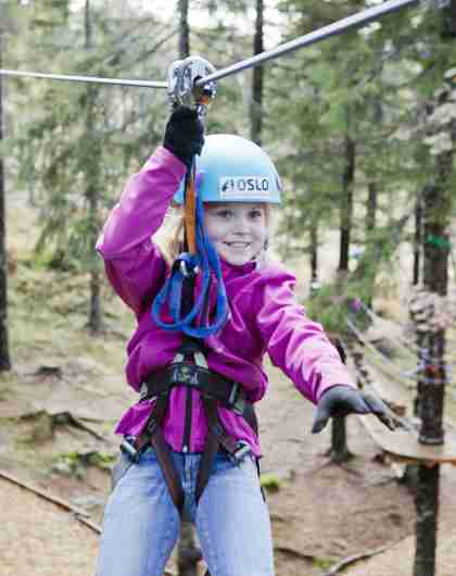A girl in a zip line in Oslo Sommerpark, Eastern Norway