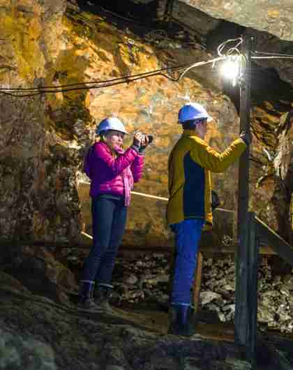 Three people are exploring Olav’s mine in Røros in Trøndelag, Norway