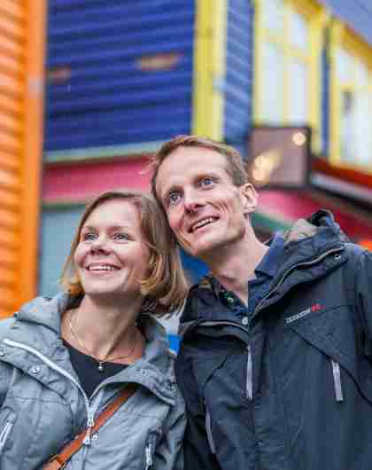 Two people on a weekend trip to Stavanger in Fjord Norway, in the colourful street Øvre Holmegate