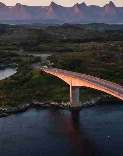 A bridge connecting Herøy to another island in Helegeland, Northern Norway. In the background, the mountain range The seven sisters.