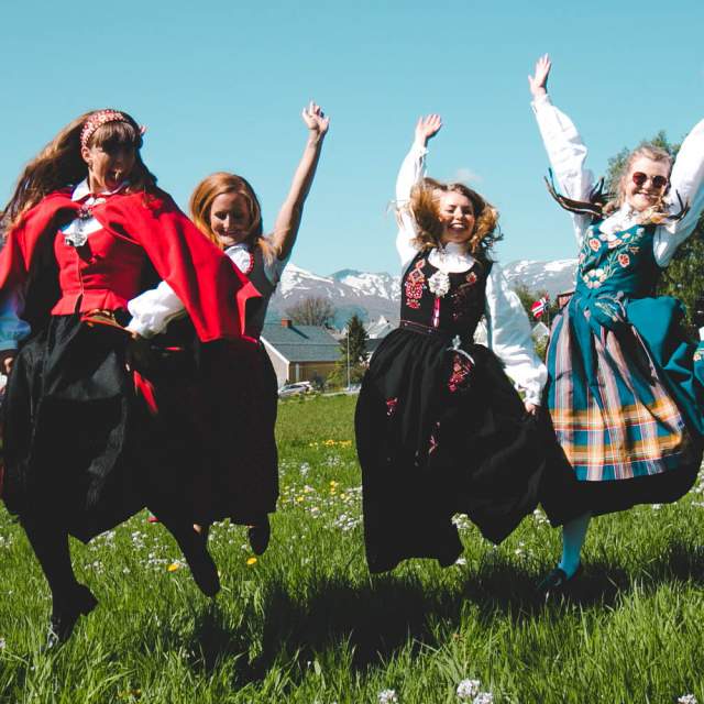Four girls out on the field wearing bunad, the Norwegian traditional costume in Volda in Fjord Norway