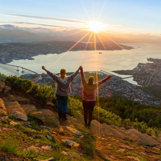 Two women are hiking up the Sherpa staircase to Mount Storsteinen in Tromsø, Northern Norway