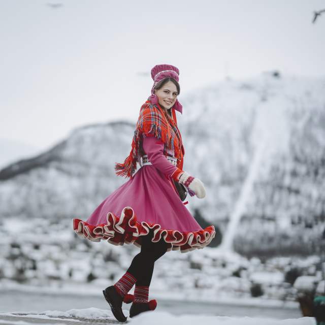 A woman is wearing traditional sami clothing in Tromsø, Northern Norway
