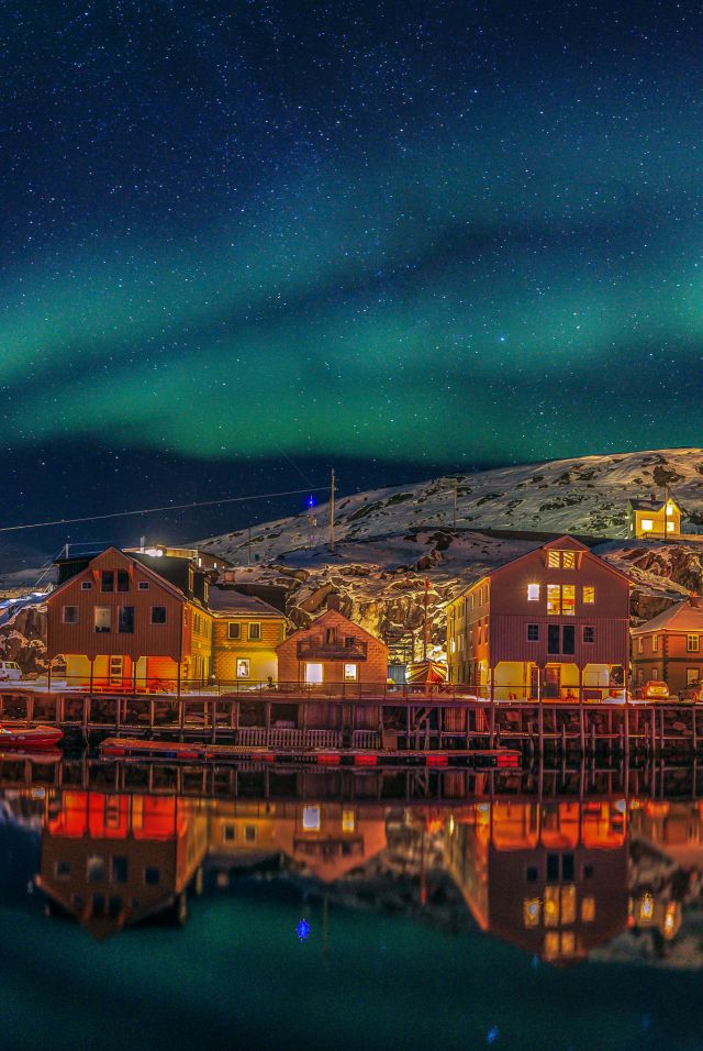 Fisherman's cabins under the northern lights in Nyksund in Vesterålen, Northern Norway