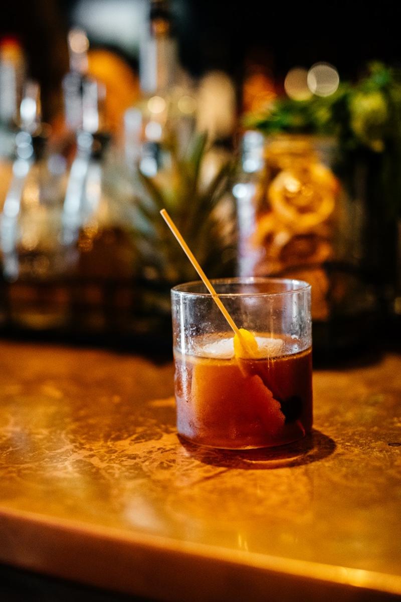 A craft cocktail with stirrer from Apothecary 330 in Fort Lauderdale