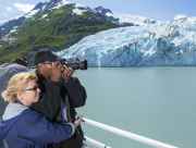Couple photographs Portage Glacier during glacier cruise