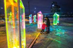 A family looking at the art installation - Prismatica on North Monroe.
