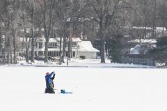 Person ice fishing on Reed's Lake.