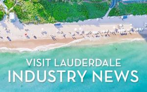 Aerial shot of a beach with "Visit Lauderdale Industry News" written in white over the crystal clear turquoise ocean