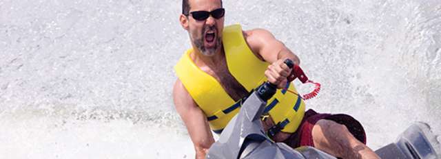 Man on a jet ski with a yellow life vest