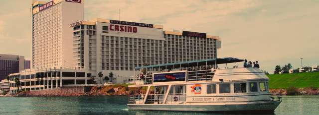 The USS Riverside floats past the Riverside Resort Hotel & Casino in Laughlin, NV