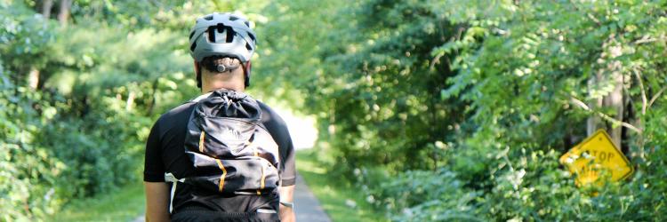 White Pine Trail biking - edit for cover image Main with backpack biking on White Pine Trail
